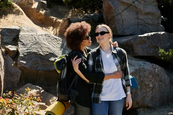 Two young women, one Black and one White, are hiking together in the wilderness. — Stock Photo