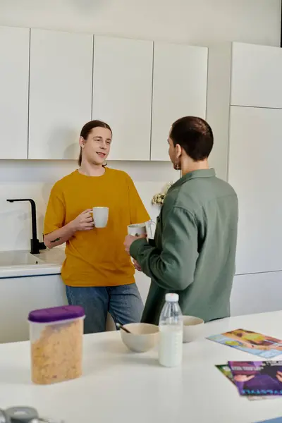 A young gay couple enjoys a relaxed morning together in their modern apartment. — Stock Photo