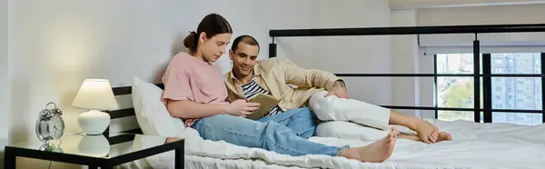 A young gay couple relaxes in a modern apartment, sharing a tender moment together. — Stock Photo