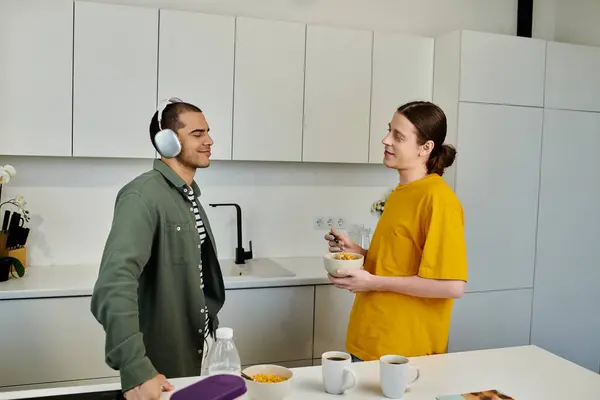 A young gay couple enjoys a relaxed morning together in their modern apartment. — Stock Photo