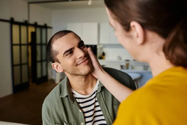 A young gay couple enjoys a moment of intimacy in a modern apartment. — Stock Photo