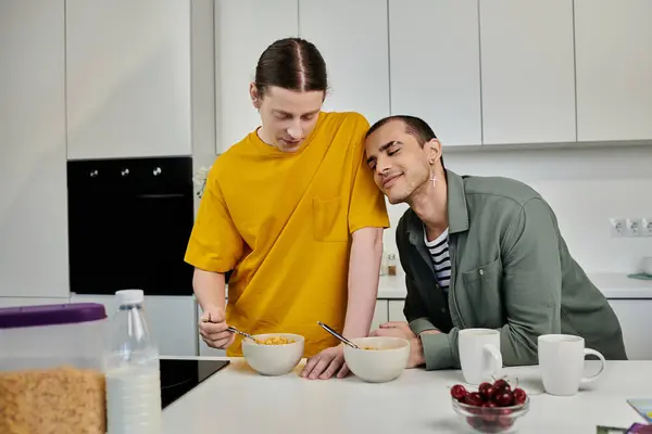 A young gay couple enjoys breakfast together in their modern apartment. — Stock Photo
