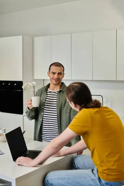 A young gay couple enjoys a casual moment together in their modern apartment. — Stock Photo