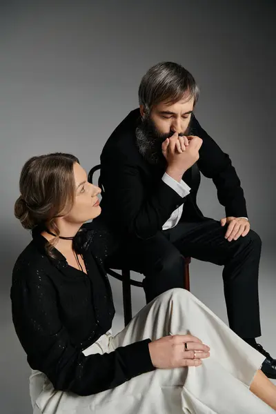 A loving couple in elegant attire pose together, creating a moment of quiet intimacy. — Stock Photo