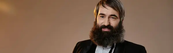 A man in a sophisticated suit poses for a portrait. — Stock Photo
