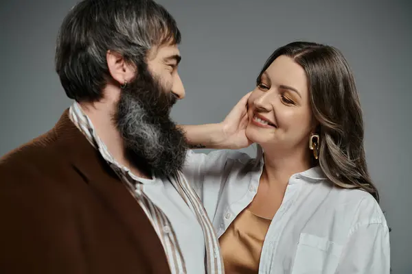 Ein Paar in eleganter Kleidung schaut sich liebevoll an, ein Moment gemeinsamer Freude, festgehalten in der Kamera. — Stockfoto
