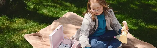 A little girl with Down syndrome plays outdoors on a sunny day. — Stock Photo