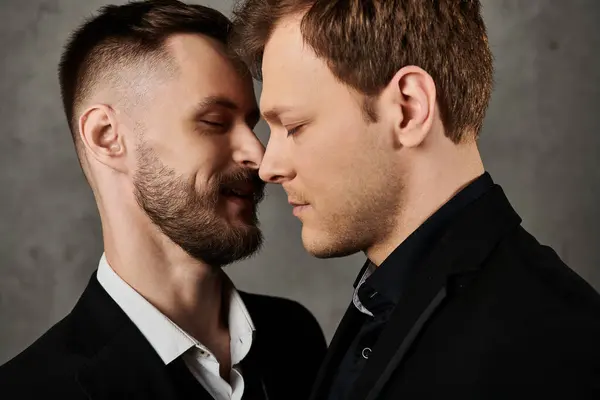 Two men in elegant suits, eyes closed, foreheads touching, exuding intimacy. — Stock Photo