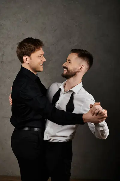 Two men in elegant suits embrace and smile at each other. — Stock Photo