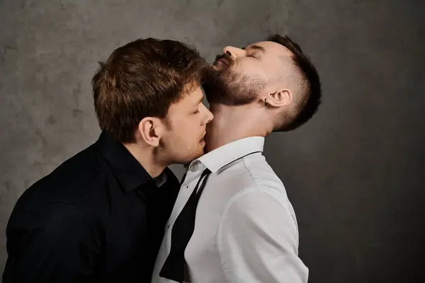 A loving gay couple in elegant suits share a tender moment. — Stock Photo