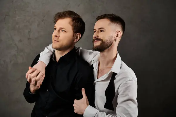 Two men in suits embrace, showcasing affection and connection. — Stock Photo