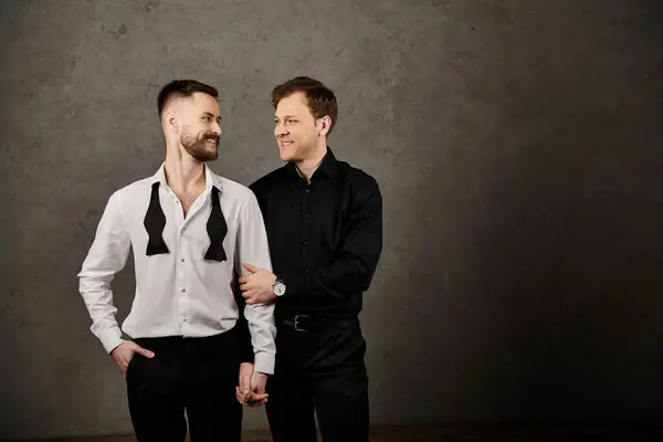 Two men in elegant suits, standing close and looking lovingly at each other. — Stock Photo