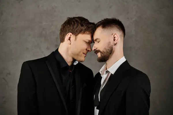 Two men in suits share a tender moment together. — Stock Photo