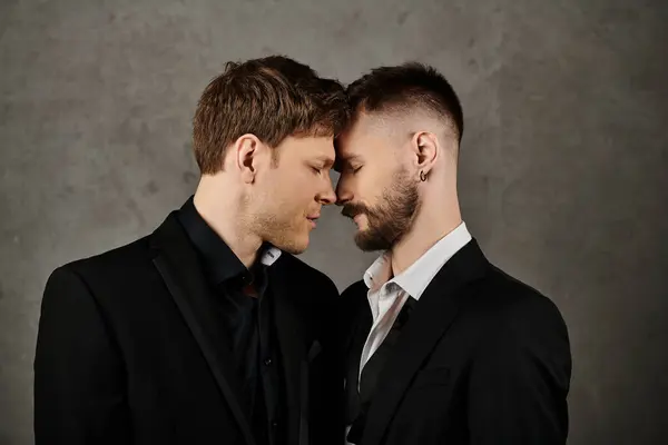 Two men in suits are close together, foreheads touching, in a moment of intimacy. — Stock Photo