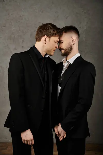 Two men in elegant suits embrace, their foreheads touching in a gesture of affection and intimacy. — Stock Photo