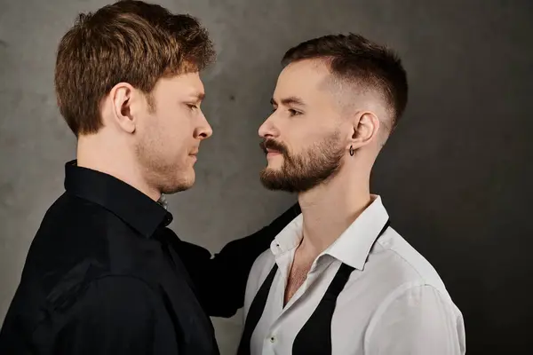 A loving gay couple in dapper suits stand close together, looking deeply into each others eyes. — Stock Photo