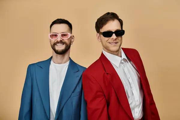 Two men in suits and sunglasses pose together, smiling. — Stock Photo
