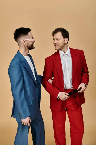 Two men in elegant suits stand close, sharing a laugh and a tender moment. — Stock Photo