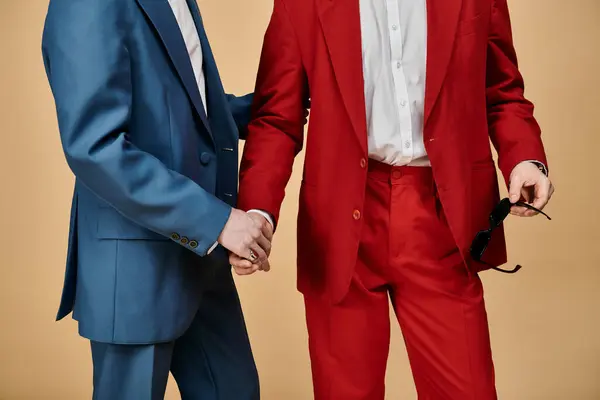Two men in suits hold hands and stand side by side. — Stock Photo
