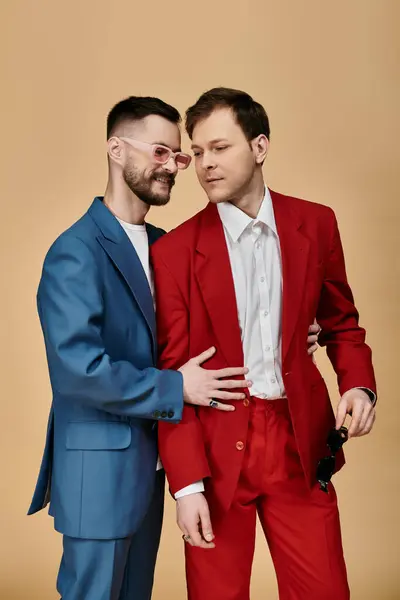 Two men in elegant suits stand close together, with one arm around the others waist. — Stock Photo