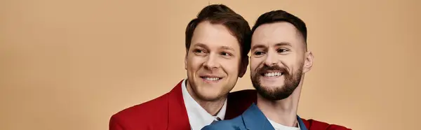 Two smiling men in elegant suits pose for a photo. — Stock Photo