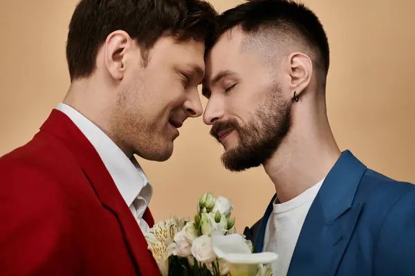 Two men in elegant suits share a loving moment, their foreheads touching. — Stock Photo
