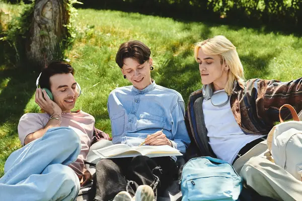 Três jovens amigos relaxam em um gramado gramado, desfrutando da luz do sol e da companhia uns dos outros. — Fotografia de Stock