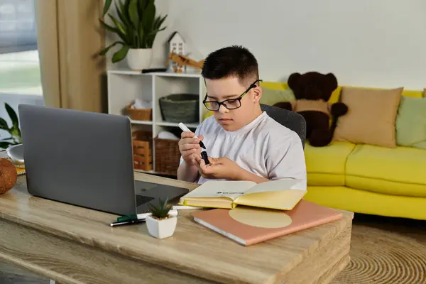 Ein kleiner Junge mit Down-Syndrom studiert zu Hause. — Stockfoto