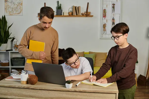 Three young boys are studying together at a desk. — Stock Photo