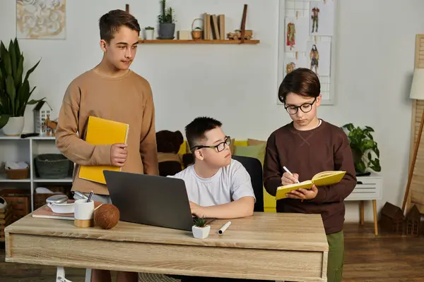 Three boys, one with Down syndrome, study together at home. — Stock Photo