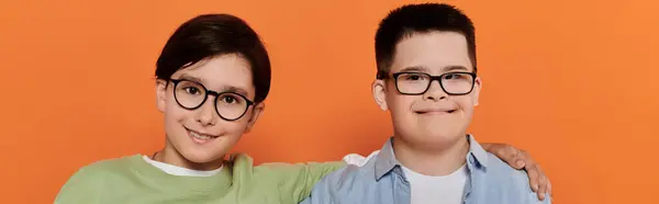 Two young boys smile at the camera, one with Down Syndrome. — Stock Photo