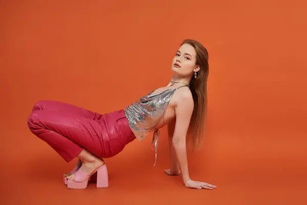 Vibrant young woman strikes a pose against colorful backdrop. — Stock Photo