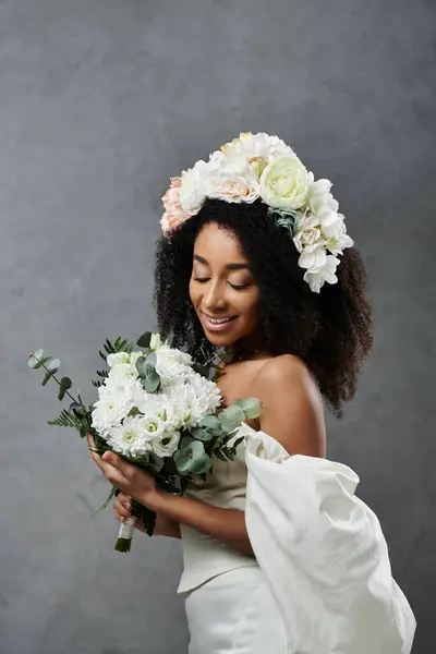 A beautiful African American bride in a white wedding dress with a floral crown and bouquet. — Stock Photo