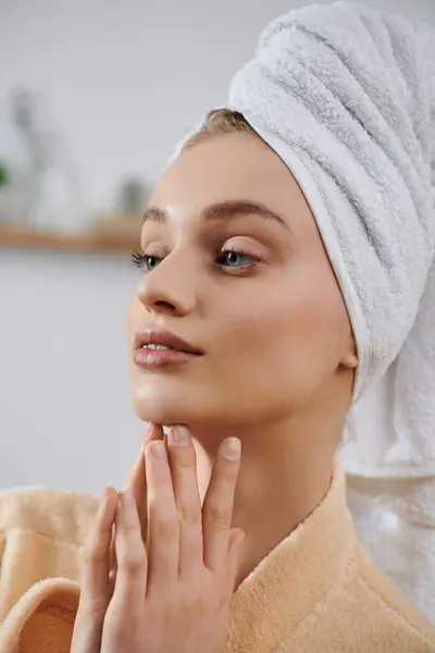 A young woman, wrapped in a towel, relaxes at home. — Stock Photo