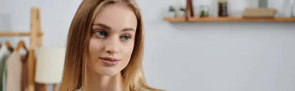 Blonde woman gazes into camera at home. — Stock Photo