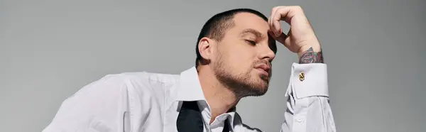 A man in a white shirt with cufflinks contemplates, with a thoughtful expression on his face. — Stock Photo