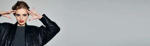 Chic woman in leather jacket strikes pose, showcasing style. — Stock Photo