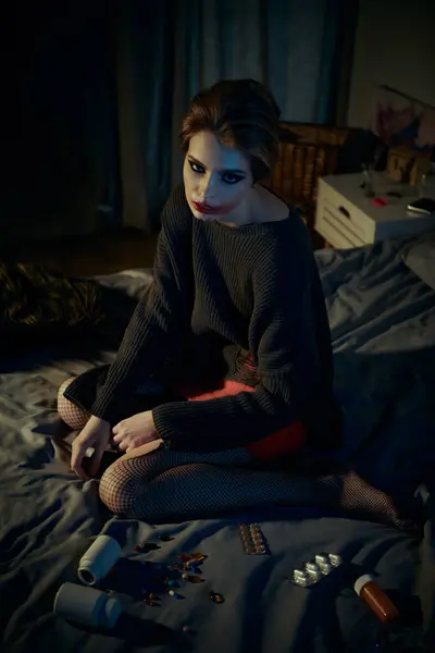 A woman in stylish attire poses on a bed with makeup on her face. — Stock Photo