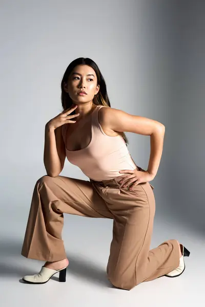 Fashionable Asian woman kneeling elegantly. — Stock Photo