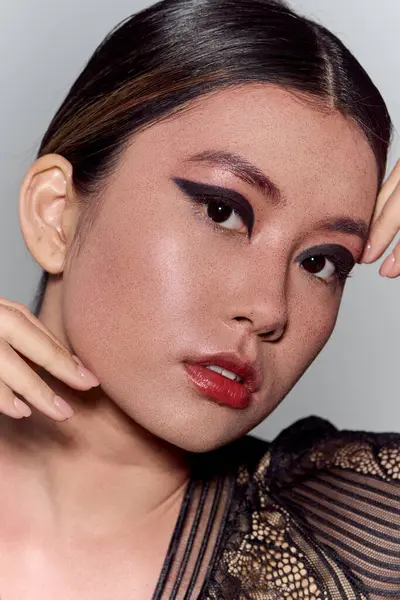 Portrait of Asian woman with dramatic eyeliner and soft expression. — Stock Photo