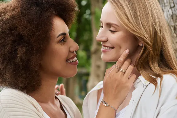 Happy African American woman and her partner share a loving gaze while enjoying the outdoors. — Stock Photo