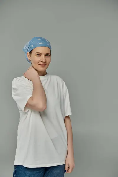 A woman wearing a blue bandana and a white shirt looks directly at the camera with a confident smile. — Stock Photo