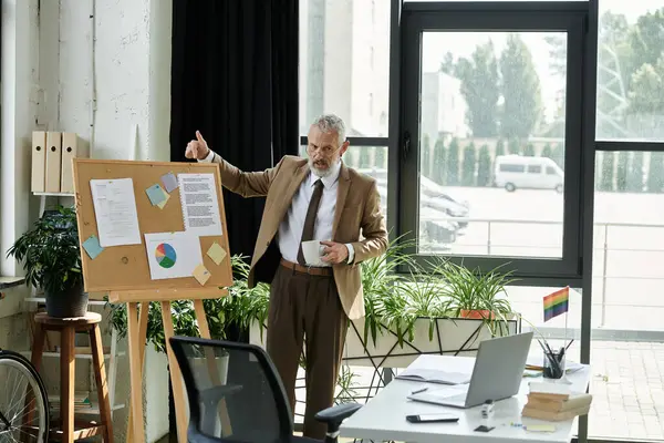 A bearded teacher gives a passionate presentation to students online, his office filled with plants. — Stock Photo