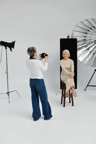 A photographer captures a portrait of her partner in a studio setting. — Stock Photo