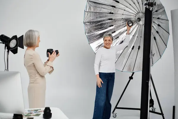 A woman photographs her partner in a photo studio, showcasing their love and creativity. — Stock Photo