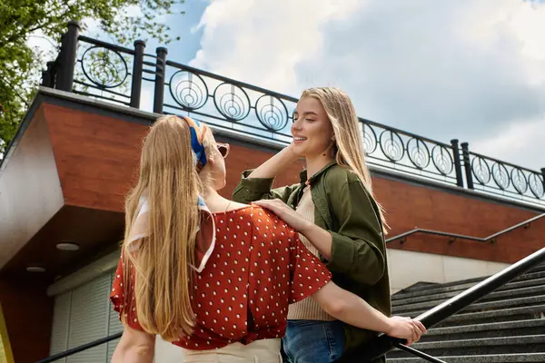 Two young women share a tender moment, enjoying a date in a city. — Stock Photo
