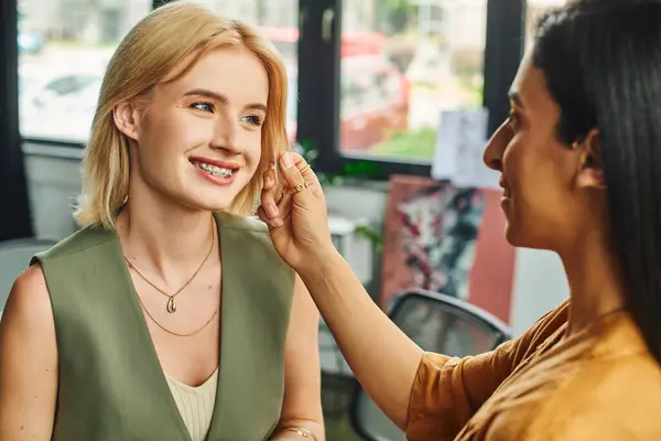 Lesbian couple in smart casual attire collaborate joyfully on a project in a modern office, exuding confidence — Stock Photo