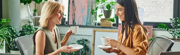 Two women enjoy a casual coffee break while working on a project in a modern office, lesbian couple — Stock Photo