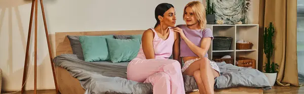 Una coppia lesbica coccola sul loro letto in un ambiente accogliente casa. — Foto stock