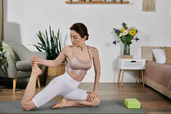 A beautiful Asian woman practices yoga and meditation in a modern apartment, surrounded by plants and natural light. — Stock Photo